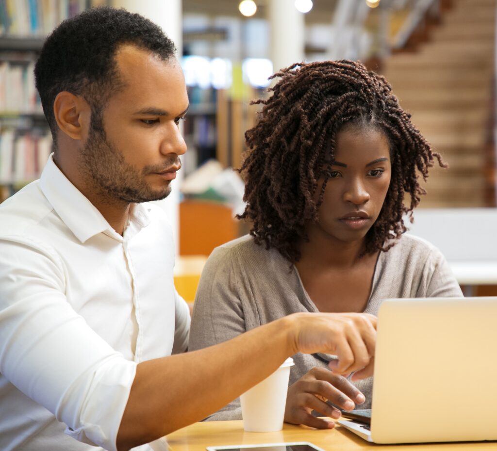 Focused people working at library. Serious adult students studying with laptop at library. Education, communication concept